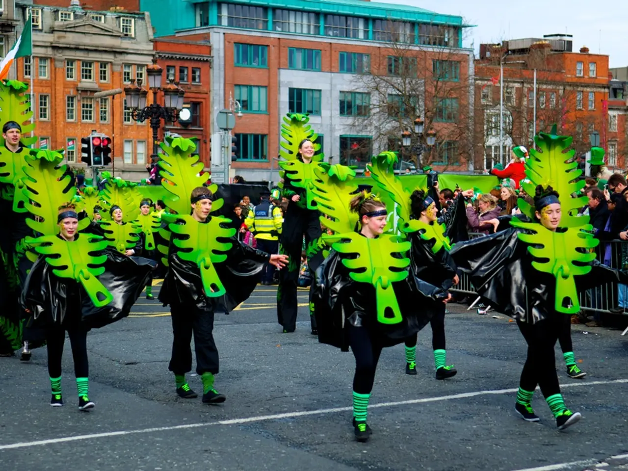 In this image, there are some persons wearing fancy dresses and walking on the road. There is a...