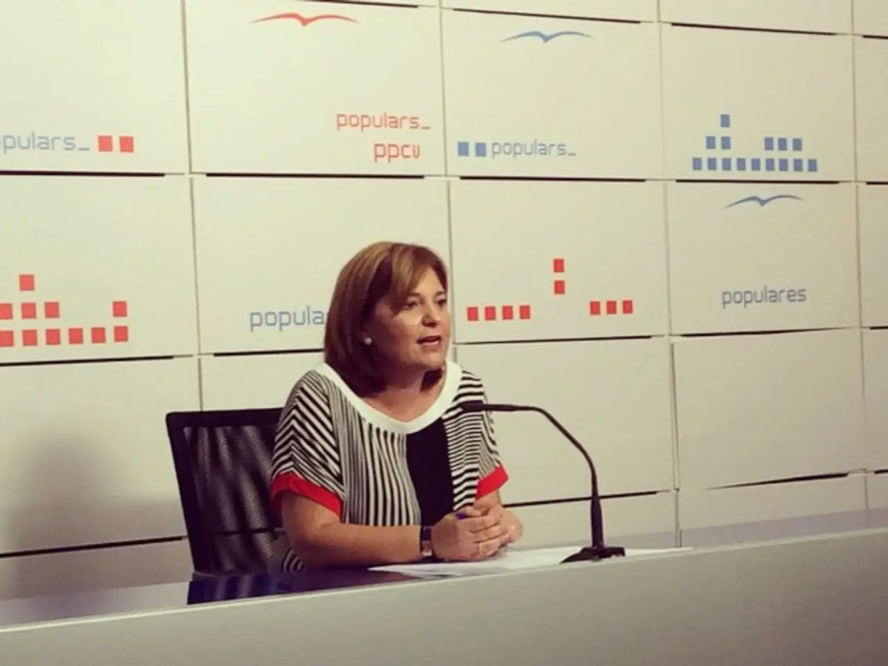 In this picture there is a lady who is sitting at the center of the image on the chair by resting...