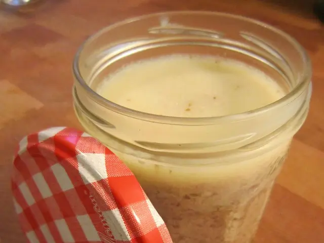 In this image, we can see a jar with liquid and there is a cap on the table.